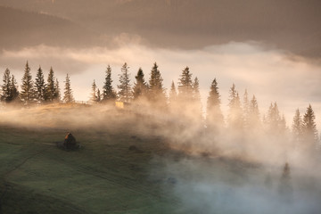 Mountains rural landscape at foggy sunrise