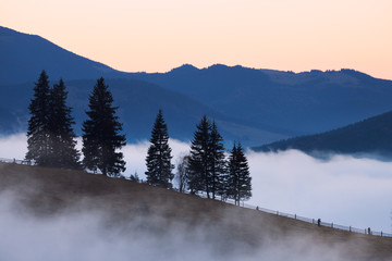 Mountains rural landscape at foggy sunrise