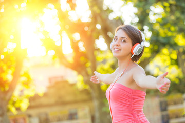 Carefree Girl with Headphones Listening Music at Park