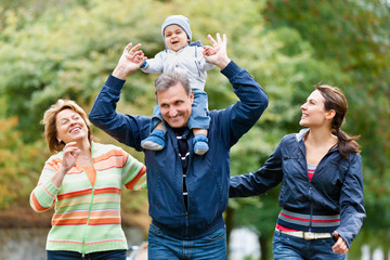 Smiling family and grandparents in the countryside