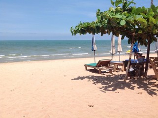 Tropical beach with sunbeds and umbrellas