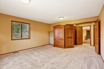 Empty bedroom interior in soft peach color with wardrobe
