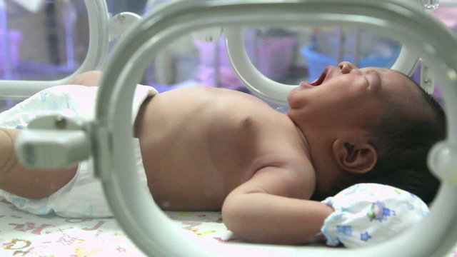 Crying newborn baby in Incubator care at nursery