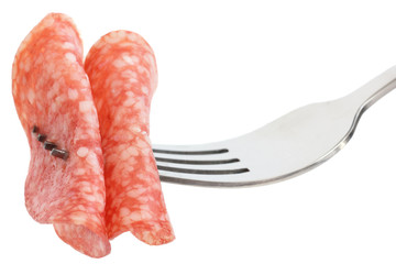 Two thin slices of salami on a fork.