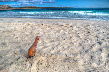 Fototapeta na wymiar bottle on the sand