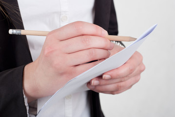 Cropped image of businesswoman writing on paper