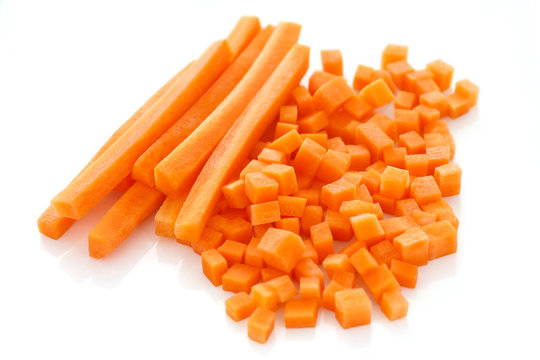 Diced and sliced carrots on white surface