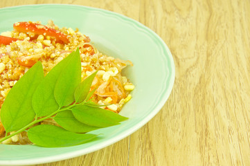 Close up green papaya salad with leaves of gooseberry