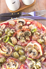 Delicious italian pizzas served on wooden table