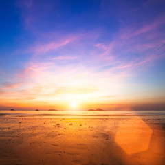 Fototapeta na wymiar Sunset over ocean at low tide.