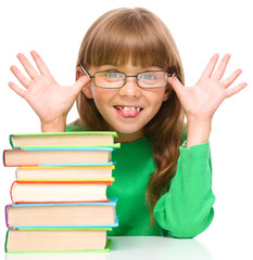 Little girl is reading a book