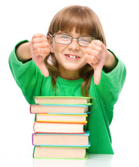 Little girl is reading a book