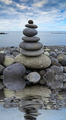 Fototapeta premium stack of stones on the beach and sea background.