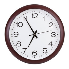 Round clock shows five minutes to seven