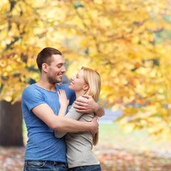 smiling couple hugging and looking at each other