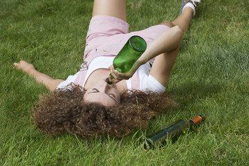 Teenage drinking problem Girl with beer bottle - obrazy, fototapety, plakaty