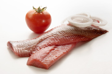 pink herring with onion and tomato
