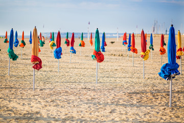 The famous colorful parasols on Deauville Beach - obrazy, fototapety, plakaty