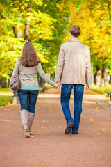 Couple walking together in park on a fall day