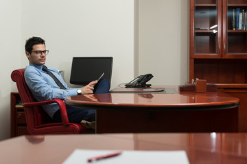 Young Man Working On Computer In Office