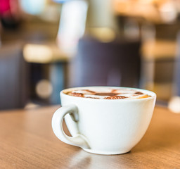 Coffee cup in coffee shop interior
