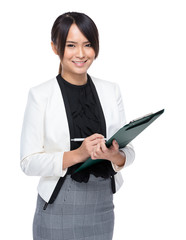 Businesswoman write on clipboard