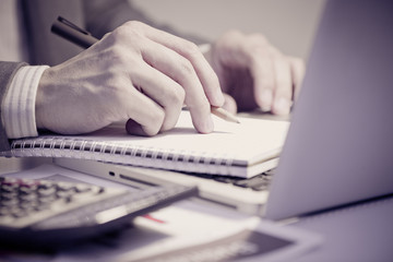Fototapeta premium Businessman analyzing investment charts with laptop. Accounting