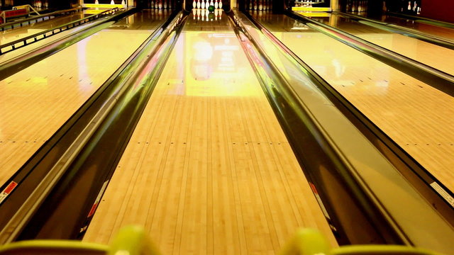 Ball rolling pushed from kids bowling ramp