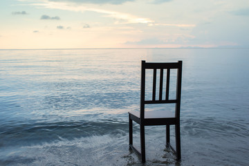 Fototapeta na wymiar Chair on the beach with sunset.