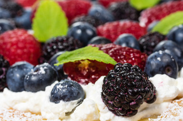 Closeup of fresh berry tart with cream
