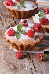 muffins with raspberries, powdered with sugar vertical