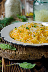 Carrot risotto in the plate on wooden table