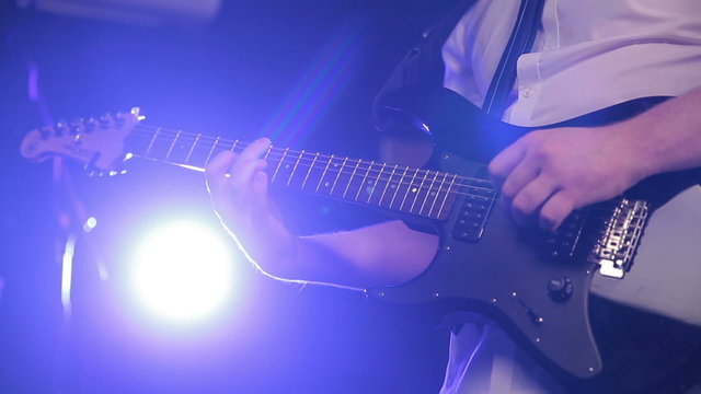 man plays guitar left-handed
