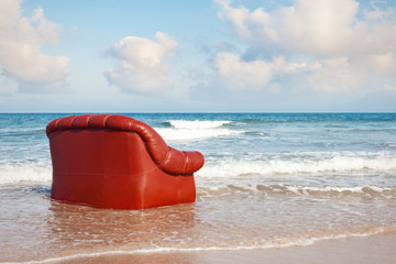 red vintage sofa in the sea