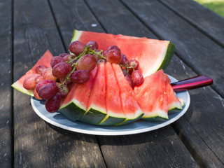 Fresh fruit on a plate, served outside