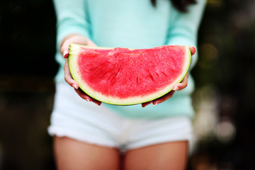 Closeup portrait of a female hands holding watermelon