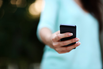 Closeup portrait of a female hand holding smartphone