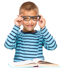 Little boy is reading a book