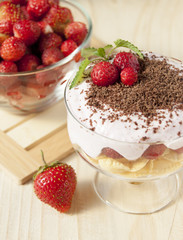 Dessert with curd cream, cereal, strawberries and chocolate.