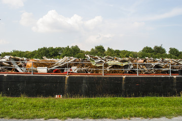 Naklejka premium Riverboat carrying cargo - scrap