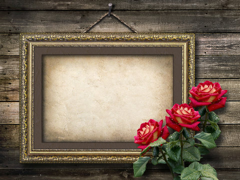 Old vintage frame for photos and a bouquet of red roses