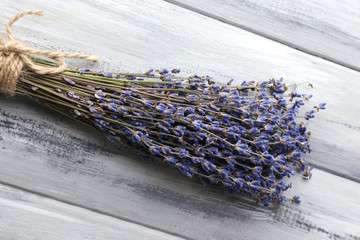 Lavender flowers on color wooden background