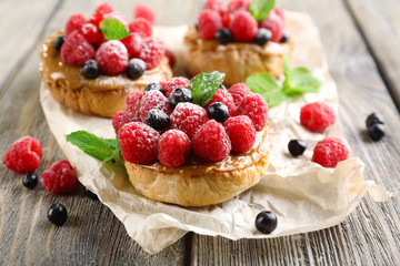 Sweet cakes with berries on table close-up