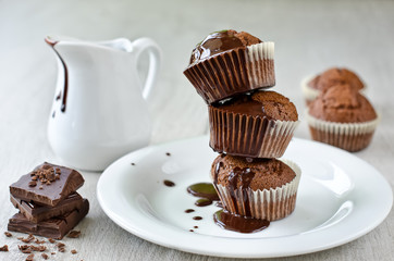 Cupcakes with liquid chocolate on a white plate