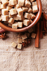 Brown sugar cubes and crystal sugar, spices in bowl