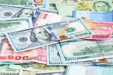 Fototapeta na wymiar Money in multi currencies with 100 USD bill on top 