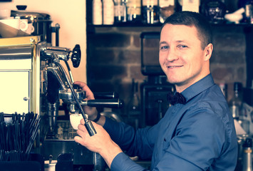 young man working as a bartender in a nightclub bar