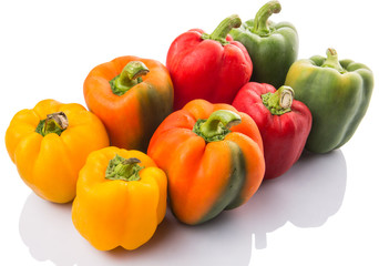 A group of different colors of capsicum over white background