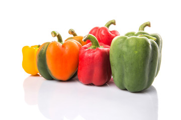 A group of different colors of capsicum over white background