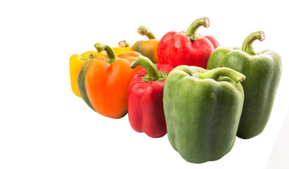 A group of different colors of capsicum over white background